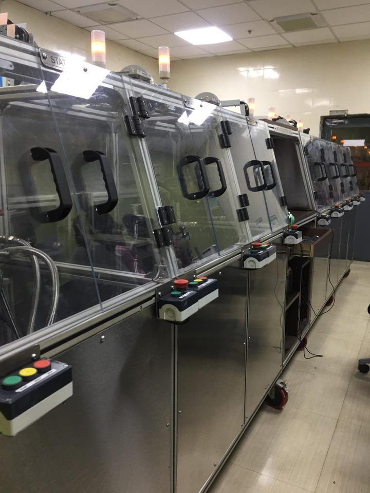 Multi-station assembly line with enclosed stations and poka-yoke