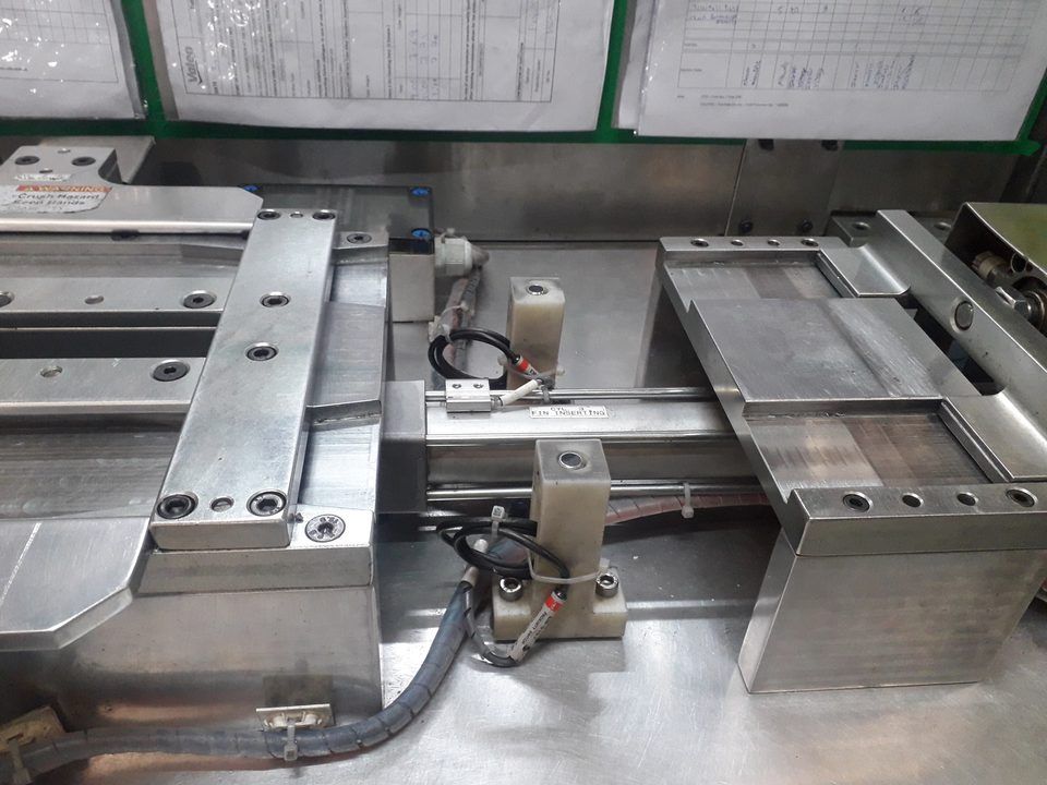 Fin inserting special purpose machine with pneumatic actuation and precision fixture